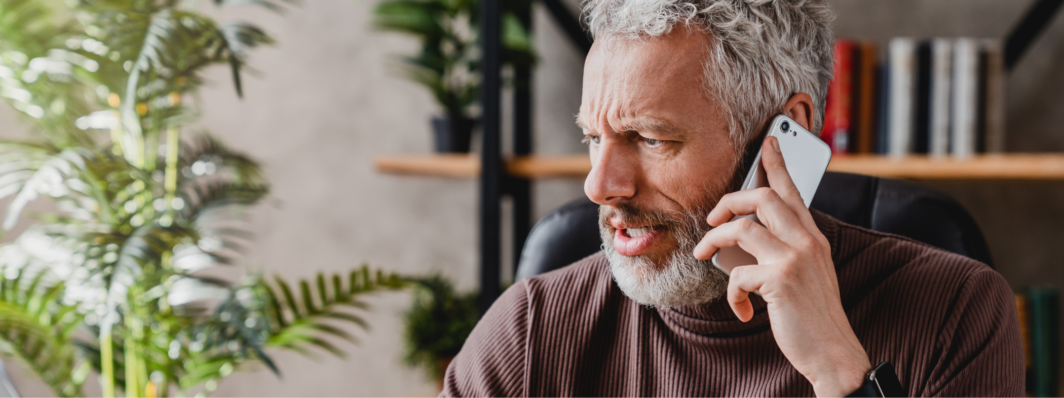 Man talking on phone with team member at dental office in Lillington