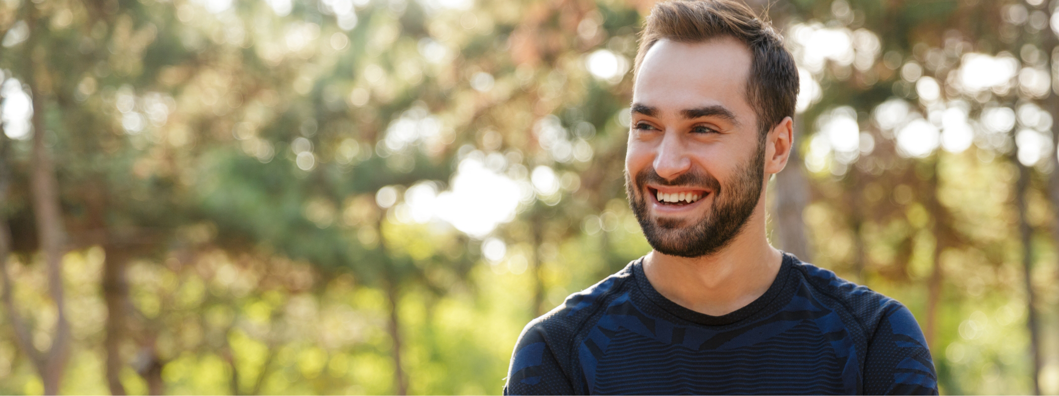 Man smiling in the sunlight with dental implants in Lillington