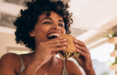 Woman biting into a burger