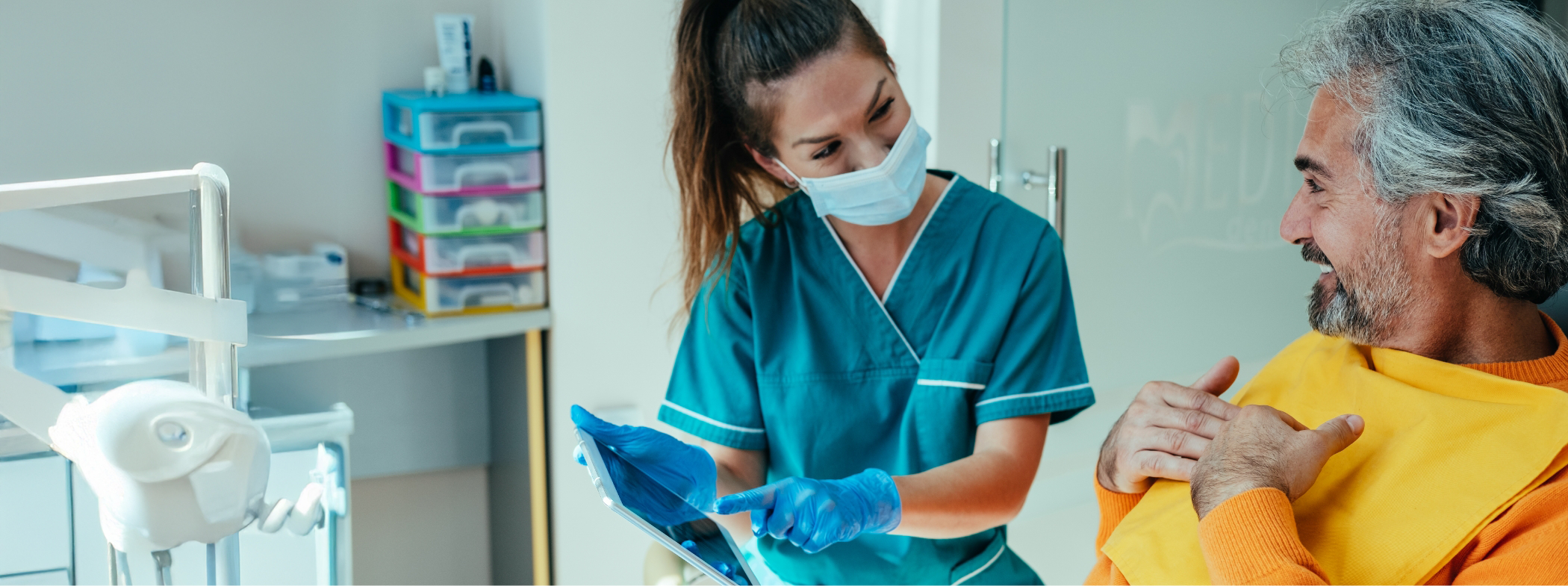 Dental team member showing a tablet to a patient