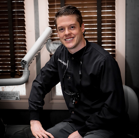 Doctor Butler smiling in a dental chair