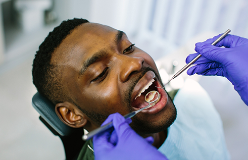 Man receiving a dental exam