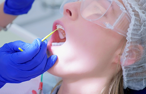 Dental patient having fluoride applied to their teeth