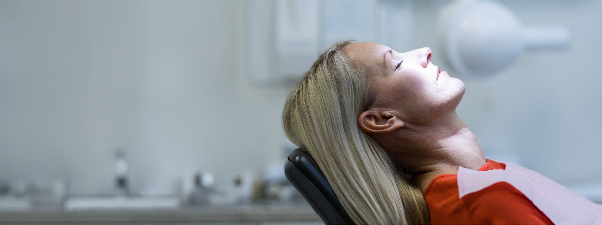 Woman relaxing in dental chair after receiving sedation dentistry in Lillington